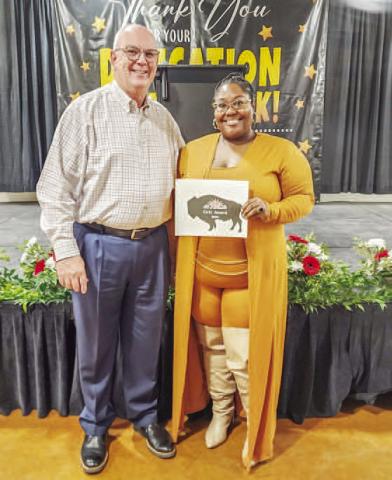GRIT AWARD- During the City of Levelland’s Employee Appreciation Banquet, City Manager James Fisher presented the GRIT Award. The award recognizes a department or group of employees that have shown “true grit”. A new award for this year, the the accolade was presented to the telecommunications department with Terez Ramos representing the department. Pictured is City Manager James Fisher alongside Ramos. (Staff photo by Dom Puente)