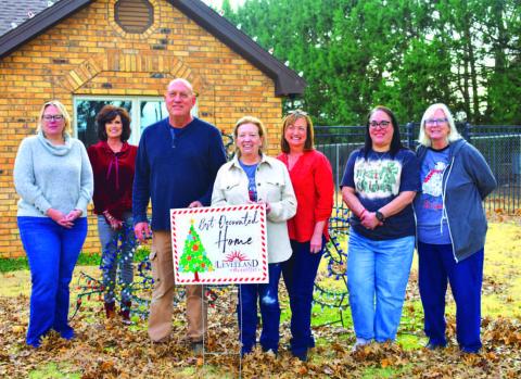 Home owners Kurt and Kelly Martin were selected as one of this years winners for the Keep Levelland Beautiful annual Best Decorated Home of the Month for the 2023 holiday season.Pictured from left to right are: Kelly Hancock, Janie Mireles, Cristal Isaacks, Kurt Martin and wife Kelly Martin, Donna Wheeler and Tammy Franklin. Awards were presented the week before Christmas.(Staff photo by Emily Campos)