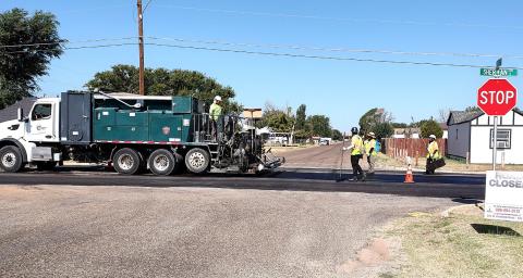 ROAD WORK ON SHERMAN - The city road project slowed traffic as microsurfacing was underway on Sherman on Wednesday.