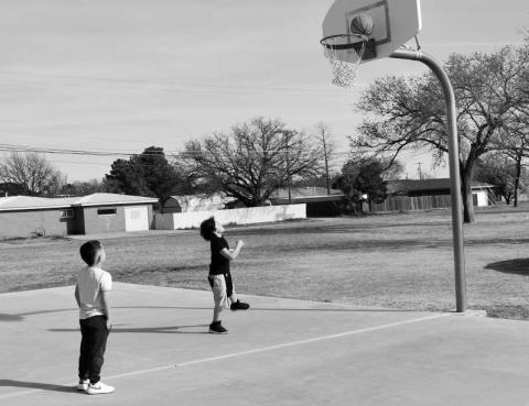 PLAYING BASKETBALL- At the Barlett Park on Tuesday there were two friends playing basketball and enjoying Spring Break. Pictured is Jaden Gonzalez 8, shooting the basketball and Cade Cristan 5, waiting for his turn to get the basketball. (Staff photo by Emily Campos)