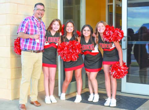 Levelland ISD started school on Thursday with some Lobo spirit from the cheer squad. The Levelland Middle School welcomed students back with some Lobo cheer and teacher hand shakes. Pictured is teacher Martin Torrez and students Kaydence Navarro, Xara Marquez, Katie Bunker, Hollyn Howard and Carley Gonzalez.(Photo Emily Campos)
