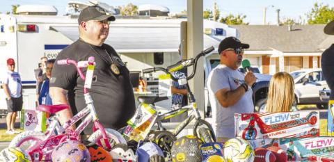 TEXAS NIGHT OUT - The Blue &amp; You organization hosted Texas Night Out on October 1 at Levelland’s Kauffman Park. Pictured is Albert Garcia calling out ticket numbers for prize giveaways. Assisting Garcia was Levelland PD Sergeant Brian Haralson. (Staff photo by Evin Thomas)