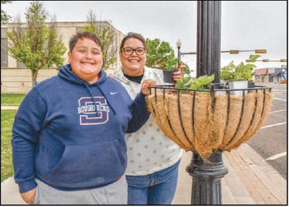 - Pictured is Luke and Esmeralda Rowand who spent their Saturday morning making downtown just a little greener for Community Planting Day. (Staff photo by: Hannah Woodrum)