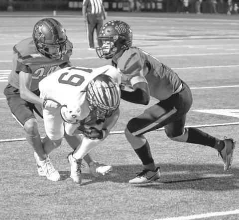 NOT OVER HERE - The Lobo defense played well as they wrapped up the offensive player for a short gain. (Staff photo by Dom Puente)