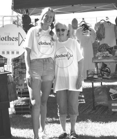 HANGING WITH GRANDMA- The Clothes Hanger Booth was one of the both’s that participated on Saturday in Sundown at the Oil Patch Day event, The Cloths Hanger was owned by Patsy Ford for 30 some years, grandmother to Caycee Holson. A two generation business that is now owned by granddaughter Caycee and pictured is Caycee Holson and Patsy Ford. (Staff photo by Emily Campos)