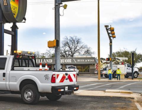 TRAFFIC LIGHT WORK - Texas Department of Transportation (TxDOT) crews were seen working on traffic lights at various intersection of College Avenue and Avenue H. Pictured is a TxDOT crew working on traffic lights at the intersection of College Avenue and 10th Street. (Staff photo by Emily Campos)