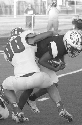 TACKLEFORALOSS- The Sundown Roughnecks traveled to Acuff to face the 3A Roosevelt Eagles on Friday night and left with a three point loss 26-29. Jadon McAdams bulldogs an Eagle rusher for a loss on the play. The Roughnecks have a bye this week and will return to the field for their district opener in Floydada October 7.(Photo Courtesy of Chris Bratcher)