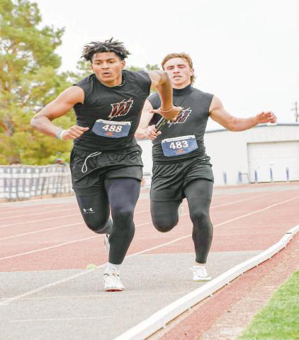 RELAY HANDOFF - Whitharral’s Greg Johnson hands off the relay baton Nate Sansom during the 4x200-meter relay this past Friday at the Regional Championships at South Plains College. (Staff photo by Jentezen Smith)