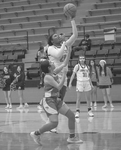 LAY IN - Levelland Loboette Destynii Jones layed the ball up over the Odessa defender at home during the team’s game. (Staff photo by Aalijah Soliz)