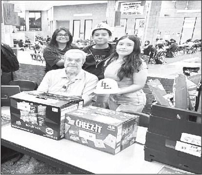 LOS LOBOS: Mr. Hill's LHS Entrepreneur class opened Los Lobos this past week as their class project. They sold $98.00 worth of merchandise in 20 minutes in the Commons area of the high school. They sold snacks, drinks and spirit gear. Pictured are Mr. Russell Hill , Paloma Escamilla, Javier Rogers, Faith Ramos (submitted photo Cristal Isaacks)
