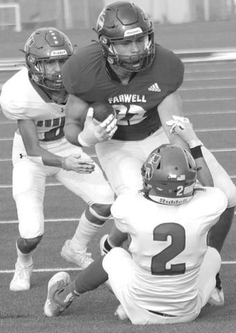 SECURINGTHETACKLE- Sundown Roughneck Jayson Martinez secured a tackle as Jaryn Flores came in to help finish off the play. The Roughnecks fell to Farwell, 49-0. Sundown will welcome Wink into for homecoming Friday September 16. Kick is scheduled for 7:30 p.m. (Photo Courtesy of Chris Bratcher)