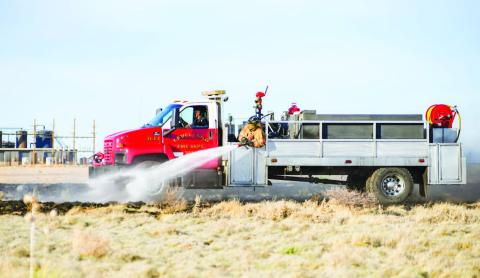 GRASS FIRE SEASON - Multiple Levelland Fire Department (LFD) units responded to a report of a small grass fire near America Road and Juneau Road, Monday evening. The responding units took turns encircling the burning area while also focusing on any hot spots. (Staff photo by Dom Puente)