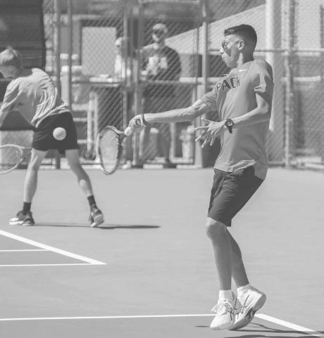 SMOOTH FOLLOW THROUGH - Junior Lobo Eben Castillano finished this fall season for the Lobo Tennis Pack with 29 wins and has a total of 65 varsity wins. Pictured is Castillano returning the ball during a doubles match at home. (Staff photo by Dom Puente)