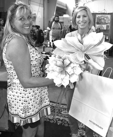 ANTIQUE DECOR GALORE!– Wendy Swarb of Sudan was shopping for antique flowers in Sherry Spiller, of Lubbock, booth at the annual Petticoats on the Prairie held Friday and Saturday at the Mallet Event Center and Arena. The ladies had more than 100 booths to find the perfect home decor. (Staff Photo by DeeLaine Ruiz)