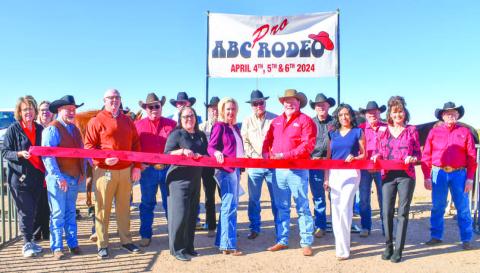 ABC RODEO - The Levelland Chamber of Commerce held a ribbon-cutting ceremony for the ABC Rodeo Wednesday for the event that lasted through the week. Pictured in no particular order are: Scott Taylor, Lorie Marquez, Janie Morales, Breann Buxkemper, Mike Loalker, King Norris, Barry Robinson, Earl Bratcher, Gene Nall, Gary White, Scotty Bowyer, Will Calfin, Raz Short, Crystal Isaacks, Mary Siders and Kelly Hancock. (Staff photo by Emily Campos)