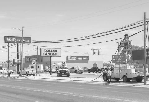 POWER LINE WORK - Crews were working on low hanging power lines and replacing the necessary line along College Avenue next to Oak Street on Wednesday. (Photo courtesy of Emily Campos)