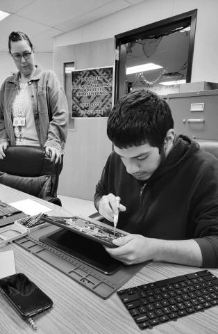 REPAIRING COMPUTERS - LHS Technology and Computer Maintenance Teacher April Austin’s LoboTech students are always busy repairing computers. Now, they’ve also started a new LHS program called Adopt-A-Tech. Lobo Tech students are responsible for students Chromebook repairs and digital designs for high school TV’s. Pictured is Mrs. April Austin and Alex Salinas. (Photo submitted by Cristal Isaacks)