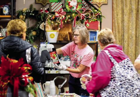 DOWNTOWN FUN - The Main Street Ladies Night Event was held last Thursday evening in downtown Levelland which allows shoppers to enjoy a night to themselves with food and drink while exploring various downtown businesses that are locally owned. Pictured are shoppers looking at the various items Lou Dees Floral and Gifts has to offer. (Staff photo by Myra Guerrero)