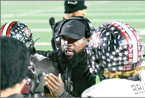 COACH ‘EM UP - Levelland Football Assistant Coach Pete Richardson coaches up several Lobo players amidst a timeout during their football game against Liberty this past Friday at Patriot Stadium. (Staff photo by Jentezen Smith)