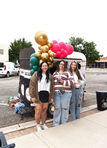 YUMMY DRINKS - Pictured are Clarissa Holland, Erica Soliz and Abi Soliz in front of the Smokin D’s trailer outside of Studio K on Saturday during the Rise, Shine and Shop event in Downtown Levelland. During the event, shoppers were treated to complementary brunch while perusing various participating shops. (Staff photo by Ada Niederhauser)