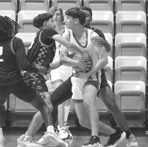 JUMP BALL - Levelland Lobos Sean Landrum and Ozzie Salano forced a turnover against the Andrew Mustangs last Tuesday night in the teams loss as the away team. (Staff photo by Aalijah Soliz)