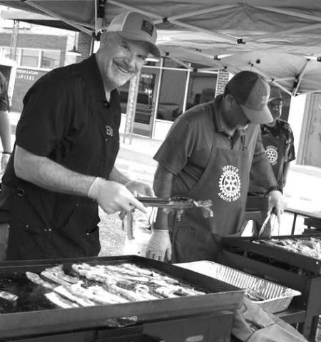 BACON BONANZA-- Bob Murray and Jorge Lopez with the Levelland Rotary Clubs, kept a watchful eye over their grittles during the Rotary’s Morning Breakfast that kicked-off the second annual Cotton &amp; Crude Festival Saturday. (Submitted Photo by Delany Jackson)