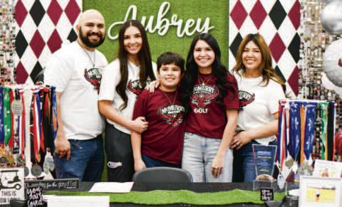 MORIN SIGNS WITH MCMURRY - Levelland's Aubrey Morin signed to play collegiate golf at McMurry University located in Abilene, Texas, this past Friday at Levelland High School. Morin is second from the right, surrounded by her family. (Staff photo by Jentezen Smith)