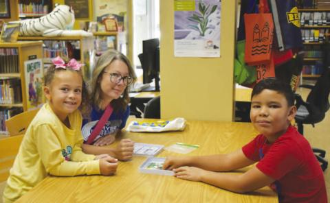 SUMMER READING – Pictured are Kylea, Rebekah and Bentley playing mini Sorry at the library on Wednesday. The week’s summer reading activity consisted of board games inside where there was air conditioning. (Staff photo by Ada Niederhauser)