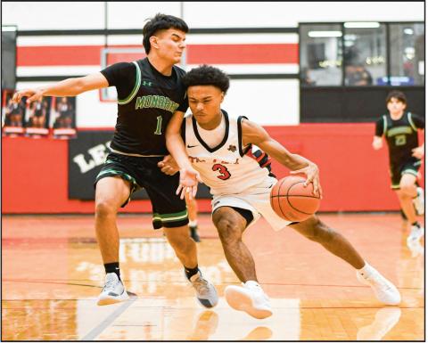 PLAYING THROUGH CONTACT - Levelland Lobos sophomore point guard Bryson Golightly plays through contact while driving to the basketball hoop during their home game against Monahans this past Tuesday night. Golightly would finish with eight points. (Staff photo by Jentezen Smith)