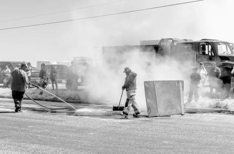BURNOUT SAFETY - Similar to years past, the Levelland Fire Department oversaw the clean up of leftover rubber left by burnout competitors and ensured the area was properly soaked during the burnout portion of the Thunder on the Plains Car Show. (Photo courtesy of Emily Campos)