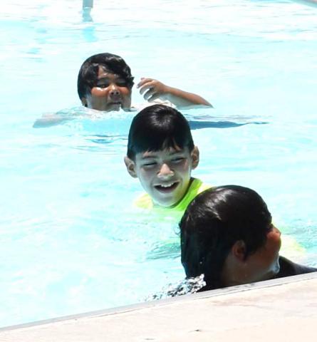 STAYING COOL – Pictured are local children playing at the Levelland City Pool. The pool is one of many way to cool off in 100 degree weather this summer. (Staff photo by Ada Niederhauser)