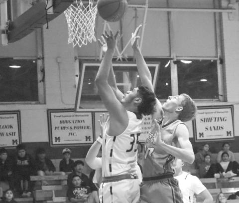 TOUGH LAY UP - Morton Indian Anibal Casteneda grabbed the offensive rebound and went back up through the contact during the teams game last Friday against the Lubbock Titans at home. (Staff photo by Aalijah Soliz)