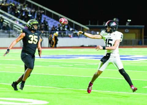 PLAYOFF PERFORMER - Levelland junior starting quarterback Ethan Salazar makes a throw on the run from a Seminole defender during their playoff football game this past Friday at Frenship High School. Salazar would end with 291 yards of total offense and three touchdowns. See full story “Levelland falls to Seminole” on page 8 (Staff photo by Jentezen Smith)