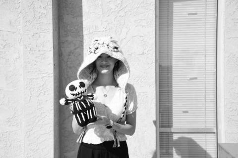 CRAFTING THE LOVE - Pictured is Rosabeth Garza with her own crocheted hooded scarf and a crocheted Nightmare Before Christmas Jack Skeleton. Garza can crochet you any character you want, just head to her Facebook, P and B Hook Creations and message her. (Staff photo by Hannah Woodrum)