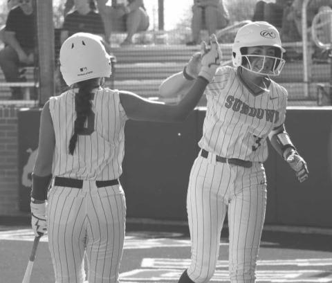 HIGH FIVE - Sundown Roughettes Destiny Garza and Ericka Posadas high-fived during the team’s game after Garza ran it in from third base to get the team a run. (Staff photo by Aalijah Soliz)