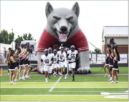 HERE COMES THE LOBOS – The Levelland Lobos football team make their entrance onto the field at Memorial Stadium for their matchup against Dalhart this past Friday night. The Lobos would end up falling short, 55-15. (Staff photo by Jentezen Smith)