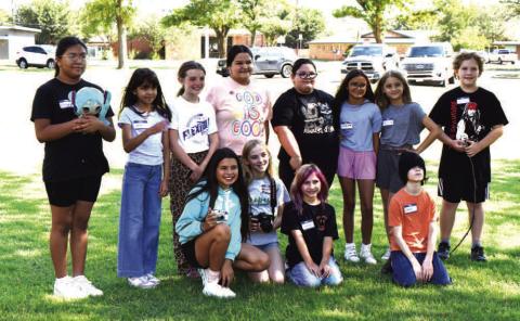FINE ARTS CAMP – The nine through 11-year-old class poses for a picture at the end of their photography class on Thursday at the Explore the Arts Camp. Hosted last week by SPC, the camp offers classes on photography, music, art and acting. (staff photo by Ada Niederhauser)