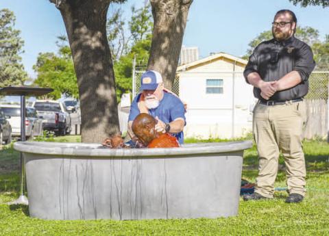 HCSO INMATE BAPTIZING - Twenty-one inmates at the Hockley County Jail were baptized Friday morning courtesy of Minister Dewey Gragson. Pictured is Gragson performing a baptism alongside HCSO Jailer McClain. Gragson has been visiting the jail every Monday to hold Celebrate Recovery lessons for interested inmates. (Staff photo by Hannah Woodrum)