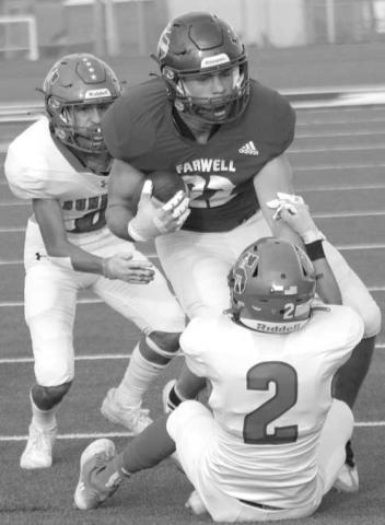 SECURE TACKLE- The Sundown Roughnecks traveled to Acuff to face the 3A Roosevelt Eagles on Friday night and left with a three point loss 26-29. Jayson Martinez secures as a tackle as Jaryn Flores comes in to help finish the play. (Photo Courtesy of Chris Bratcher)