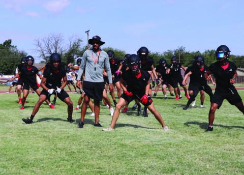 WARMUPS - The Levelland Lobo Football Team began their morning warm-up routine with Athletic Director and Head Coach Lyle Leong watching his players stretch. (Staff photo by Aalijah Soliz)