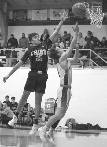 HIGH - Whitharral Panther Brolin Kennedy layed the ball up during the teams fast break opportunity last Tuesday night against the Morton Indians at home where Morton Indian E.J. Rivas jumped with him to play good defense and force a tough shot. (Staff photo by Aalijah Soliz)