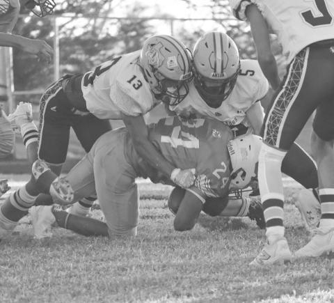 RALLY - Anton Bulldogs Adrian Castillo and Lano Castillo wrapped up the Eagle ballcarrier last Friday night during their game in Motley County. (Staff photo by Aalijah Soliz)