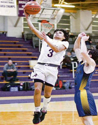 TAKIN’ FLIGHT - Anton Bulldog Shooter Campos takes flight to score the basket with a Wellman Union defender guarding him during their game this past Friday night at Anton High School. (Staff photo by Jentezen Smith)