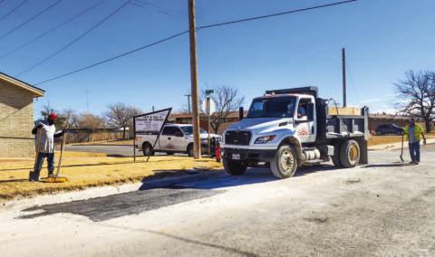 POTHOLE REPAIRS - A crew with the Levelland Street’s Department convened at the corner of 13th Street and Avenue K to repair a pothole, Thursday afternoon. Pictured is one of the crew passing over the repaired area multiple times to help pack down the newly laid material. (Staff photo by Dom Puente)