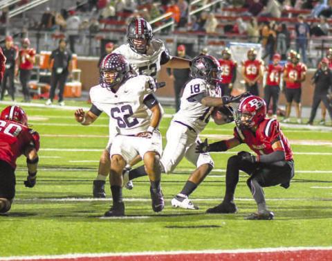 FINISHINGTHE DRIVE - Points came at a premium for the Levelland Lobos during Friday night’s matchup against the Borger Bulldogs. The Lobos would put up 14 points and hold off the Bulldogs to secure their first district win. Pictured is RB Noah Martin finding an open lane thanks to his offensive lineman Zarian Valderas and Casen Potter then cutting across the last Bulldog defender for the walk-in touchdown in the first half. (Staff photo by Dom Puente)