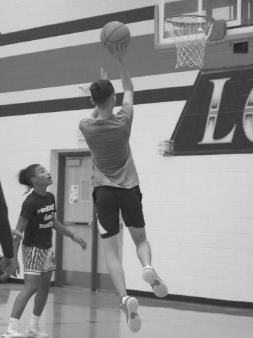 FLOATER - Levelland Lobo Anthony Gonzalez shot a floater with Bentley Sepulbeda watching this past Monday at the Levelland Middle School during open gym workouts. (Staff photo by Aalijah Soliz)