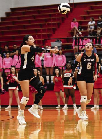 PASS IT AROUND - Senior opposite hitter Yara Carillos passes the volleyball as Hailee Estrada watches during Levelland’s volleyball match against Frenship Memorial this past Tuesday night at Levelland High School. The Loboettes would end up falling to Memorial 3-0. (Staff photo by Jentezen Smith)