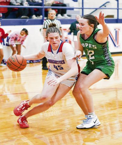 ROUGHETTE VERSUS LADY EAGLE - Sundown Roughette Kelbie Powell drives to the basket while Ropes Lady Eagle Annabelle Falls plays defense on her during their district matchup this past Friday in Sundown. (Staff photo by Jentezen Smith)