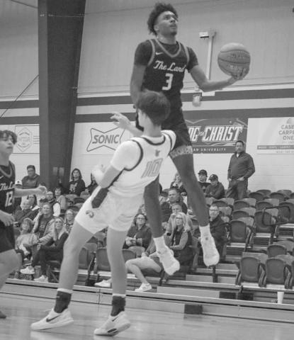 NOT TODAY - Levelland Lobo Eryk Jones avoided contact to draw the blocking foul while making the layup during the team’s game against Lubbock Christian. (Staff photo by Aalijah Soliz)