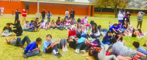 SOLAR ECLIPSE SIGHTING - Students across Levelland ISD took time out of their day to observe the rare solar eclipse that happened Monday afternoon. Pictured are students from Capital Elementary enjoying their time outside observing the eclipse with their special shades. (Photo courtesy of Emily Campos)